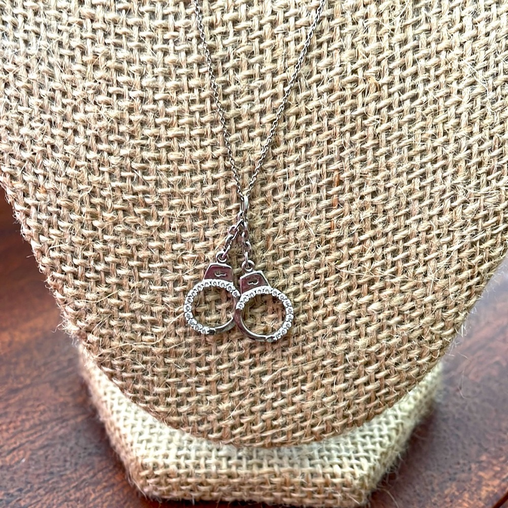 Roberto Coin diamond handcuffs w/ signature ruby on the backside.